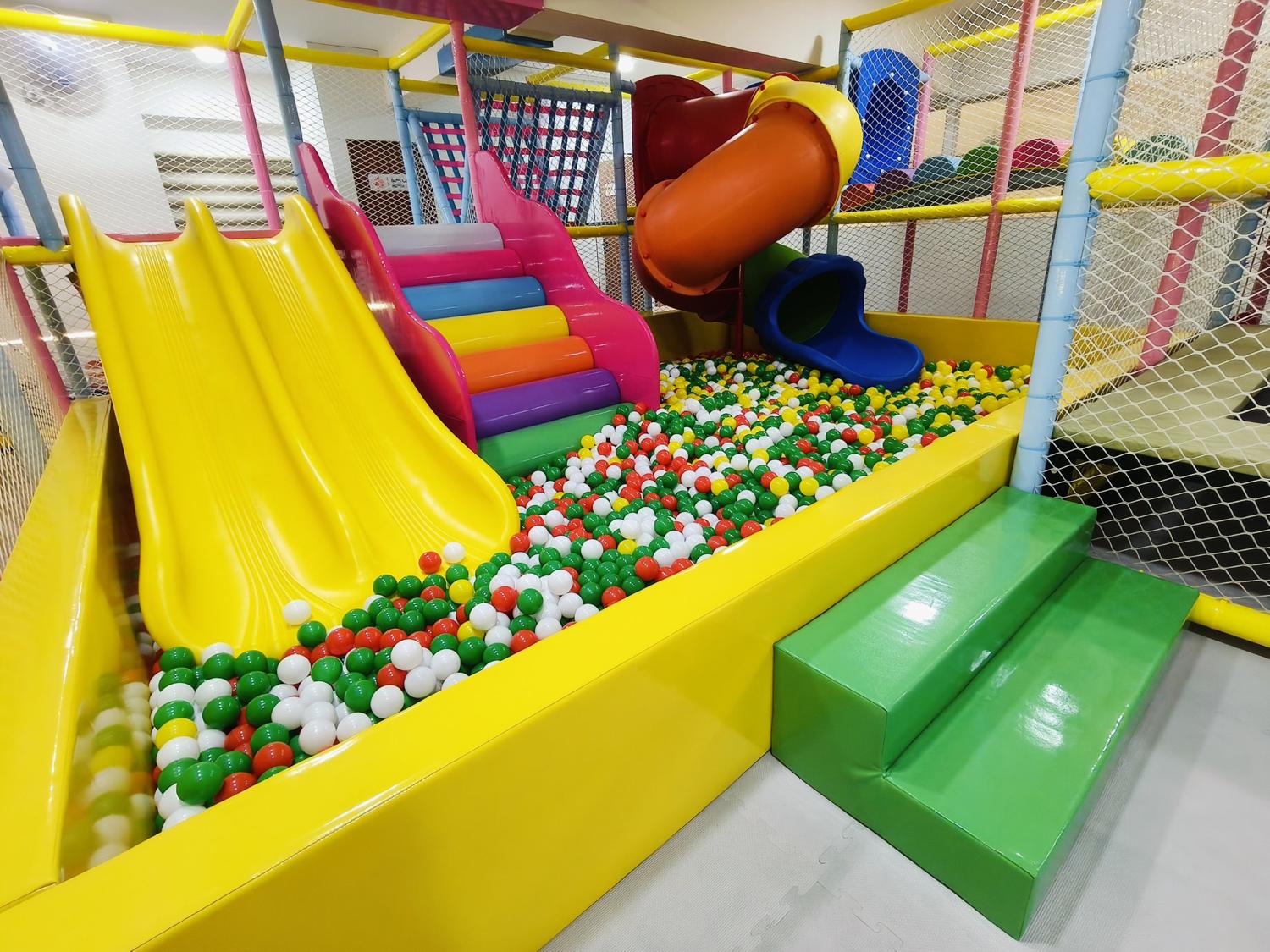 Yellow double slide, rainbow steps and tube slide into the MoonHop ball pit