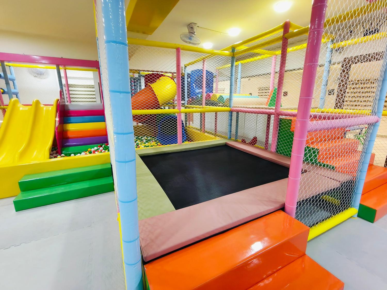 Padded trampoline inside the soft play structure